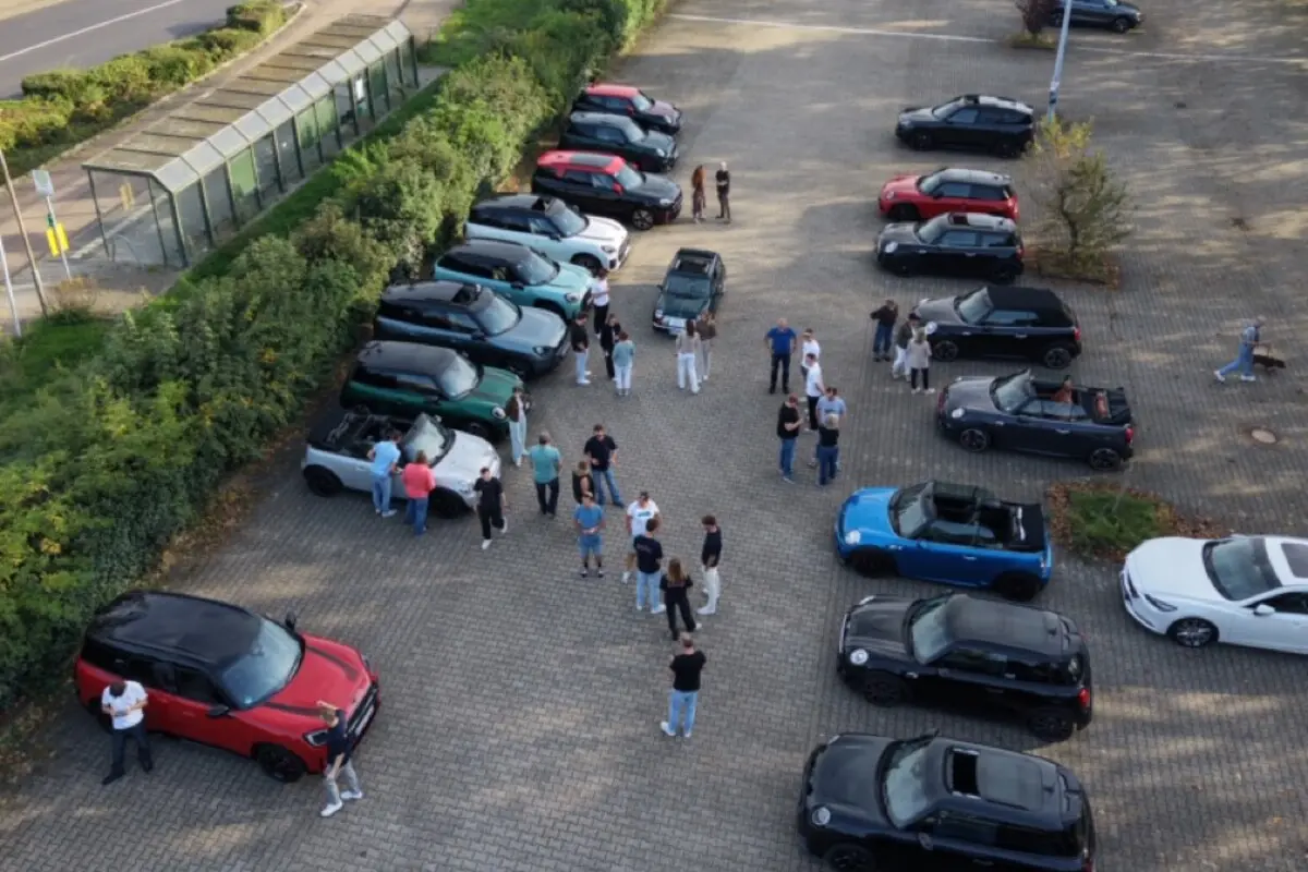 Ein Bild des Parkplatzes als Start der MINI Ausfahrt des Autohauses Fett & Wirtz mit den Teilnehmern.