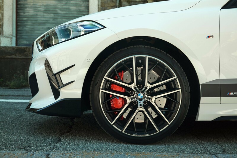 Die Frontansicht des BMW M135i xDrive mit Felgen im 10-Speichen-Design und roten Bremssatteln.